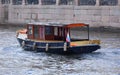 A pleasure tourist boat sails along the river along the granite embankment Royalty Free Stock Photo