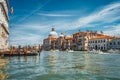 Pleasure tourist boats on Grand Canal and Basilica Santa Maria della Salute, Venice, Italy Royalty Free Stock Photo