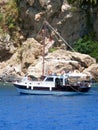 Pleasure tourist yacht in the Mediterranean Sea against the background of the rocks of the Taurus Mountains Royalty Free Stock Photo