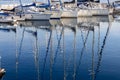 Pleasure yacht masts in the water reflection on Lake Garda in Italy Royalty Free Stock Photo