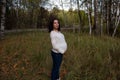 Pleasured pregnant woman autumn park Royalty Free Stock Photo