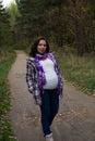 Pleasured pregnant woman autumn park Royalty Free Stock Photo