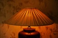 Pleating lampshade with warm light in dark room, closeup