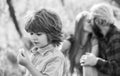 Pledge of love. Little child with couple kissing on background. Small child hold spring flower. Cute boy child sunny day