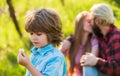 Pledge of love. Little child with couple kissing on background. Small child hold spring flower. Cute boy child sunny day