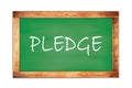 PLEDGE text written on green school board