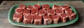 Plentiful Plate of Raw, Vibrant Cuts of Uncooked Red Meat on Display in Rustic Kitchen Setting Royalty Free Stock Photo