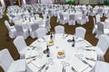 Plenty of big round tables and chairs covered with white tablecloth are set for a meal in the Gorky Gorod restaurant. Wide angle i Royalty Free Stock Photo