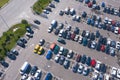 Plenty of cars in the packed parking lot in straight rows from a bird`s-eye view
