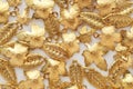 Plenty of gold shining metal leaves. Jewelry findings Royalty Free Stock Photo