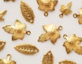 Plenty of gold shining metal leaves. Jewelry findings Royalty Free Stock Photo