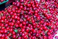 Plenty of red cherries with stems, harvested, on market stall in Kutaisi Central Market (Green Bazaar, Mtsvane Bazari