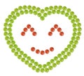 Plenty of red and green pills shaped in heart form with happy face sign inside