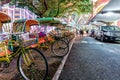 Plenty of yellow bicycles parked in a row at Grand Lisboa Hotel and Casino at night on city street illumination background