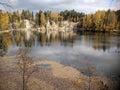 Lake in Adrspach rock town in Czech Republic covered by yellow leaves