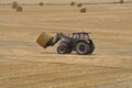 Tractor harvester roll straw at Plerin Royalty Free Stock Photo