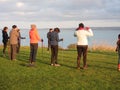 Hikers doing warm-up movement on Pointe du Roselier in Plerin