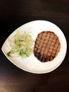 pleskavitsa cutlet and fresh vegetable salad on a white plate Royalty Free Stock Photo