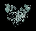 Plexiglass broken in many pieces heart shape. Green plexiglass broken glass hit impact and scatter with sharp of heart and risk Royalty Free Stock Photo