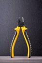 Plier with black and yellow handle.