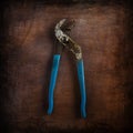 Plier tool corroded photography in top of paint background