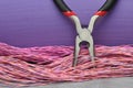 Pliers and cables on grey metal surface Royalty Free Stock Photo