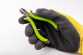 Pliers for cutting wire held in the palm of your hand. Cable cutter and hand in a clean work glove Royalty Free Stock Photo