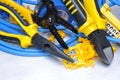 Pliers with electrical component kit on grey metal background Royalty Free Stock Photo