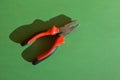 pliers on a green background. a tool for repairing in the house. Royalty Free Stock Photo