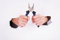 Pliers in the hand of a girl. Symbol of hard work, feminism and labor day. Isolate on white background Royalty Free Stock Photo