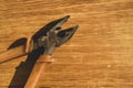 Pliers with orange handles on wooden background. working tool Royalty Free Stock Photo