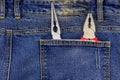 Pliers in pocket of blue jeans Royalty Free Stock Photo