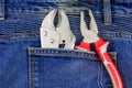 Pliers in pocket of blue jeans Royalty Free Stock Photo