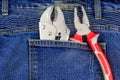 Pliers in pocket of blue jeans Royalty Free Stock Photo