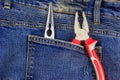 Pliers in pocket of blue jeans Royalty Free Stock Photo