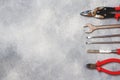 Pliers, screwdrivers and wrench combination on grey concrete background with copy space. Professional ergonomic repair tools Royalty Free Stock Photo