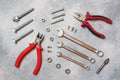 Pliers, screwdrivers and wrench combination on grey concrete background with copy space. Professional ergonomic repair tools Royalty Free Stock Photo