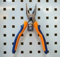 Pliers secured to the panel for workbench tools