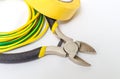 Pliers tool and wires for electrician close up, service and repairing concept on gray background Royalty Free Stock Photo