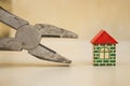 Pliers and toy house