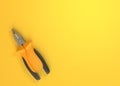 Pliers on a yellow background with copy space