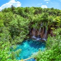 Plitvicer Lakes, Croatia: A beautiful, refreshing waterfall that flows into a turquoise lake surrounded by a green forest