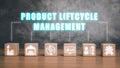 Wooden block on desk with roduct lifecycle management ion on vitual screen Royalty Free Stock Photo