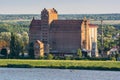 Plock, Poland - August 12, 2021. Old cereal elevator on the shore of Vistula river