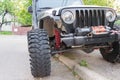Ploiesti, Romania - August 13, 2018: closeup of Jeep car showing headlights, winch, coil suspensions and off road wheels