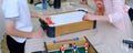 The plot shot of an air hockey game on a table Portable table hockey includes plastic hockey blades, a mini puck and
