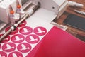 plotting machine cuts round peace dove stickers from pink adhesive foil