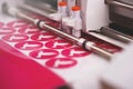 plotting machine makes multiple stickers with peace dove symbol from pink adhesive foil Royalty Free Stock Photo