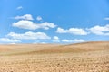 Ploughed arable plowing agricultural land plowed for crops under blue sky with clouds conceptual background with