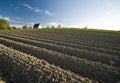 Ploughed field and house